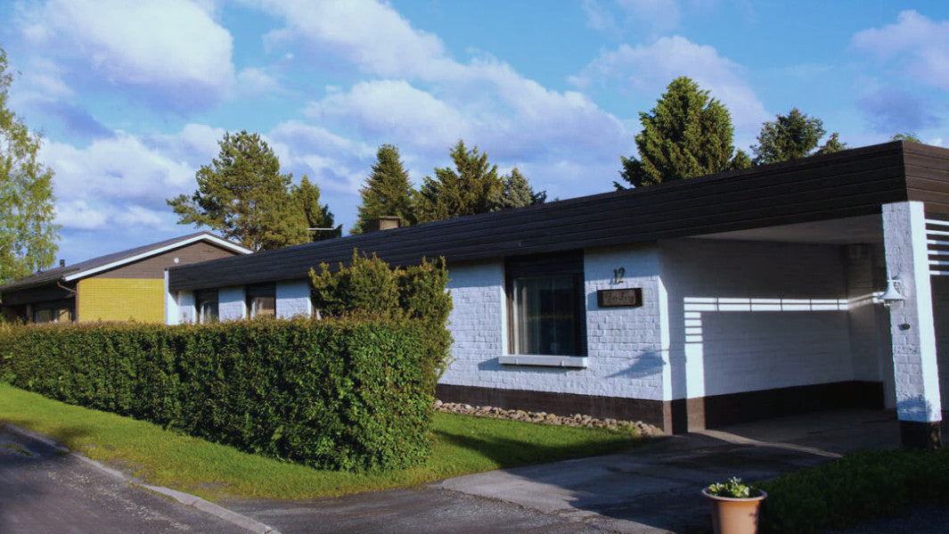 A customers's white house in a neighborhood featuring a Mobair smart ventilation system.